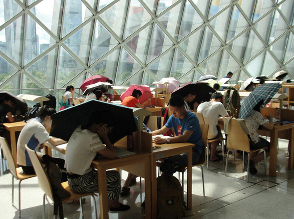 被太陽暴曬的一側(cè),，大家打傘看書。