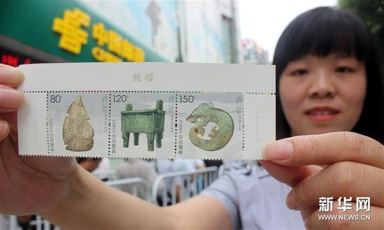7月13日,，一名集郵愛(ài)好者在江蘇蘇州郵政局展示剛購(gòu)買的《殷墟》特種郵票,。