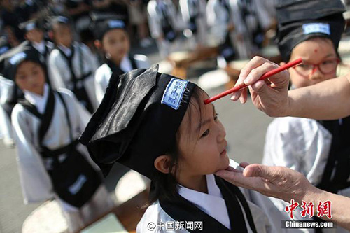 　　8月31日百余小學(xué)新生在南京夫子廟大成殿前“開筆破蒙”,，通過向孔子像行禮、誦讀《論語》,、學(xué)寫“人”字,、朱砂開智、聆聽?zhēng)熼L(zhǎng)寄語等,，宣告正式成為一名學(xué)生,。