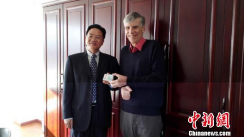 　圖為云南省外國(guó)專家局向高力行博士頒發(fā)云南省首張《外國(guó)人工作許可證》?！＄娦?攝