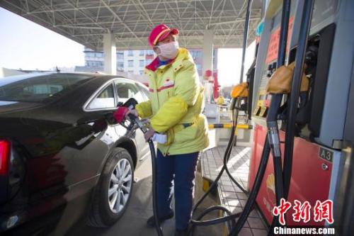 資料圖：山西太原,，加油站工作人員正在給車輛加油,。張?jiān)?攝