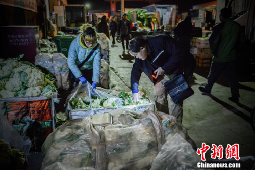 凌晨正在批發(fā)蔬菜的老丁,。<a target='_blank' href='http://www.chinanews.com/' >中新網(wǎng)</a>記者 富宇 攝