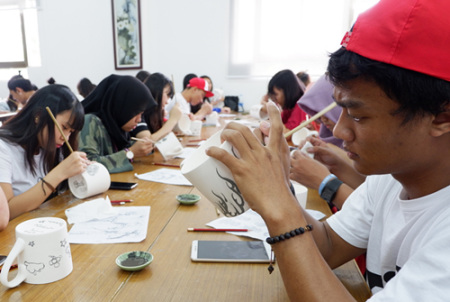 印度尼西亞學生正在繪制青花瓷茶杯圖案,。(華僑大學華文學院供圖：楊惠晶 張芬妮)