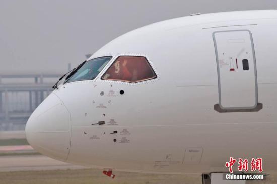 5月5日，首架國產(chǎn)大飛機(jī)C919在上海成功首飛,。圖為機(jī)組人員揮手示意,。張亨偉 攝