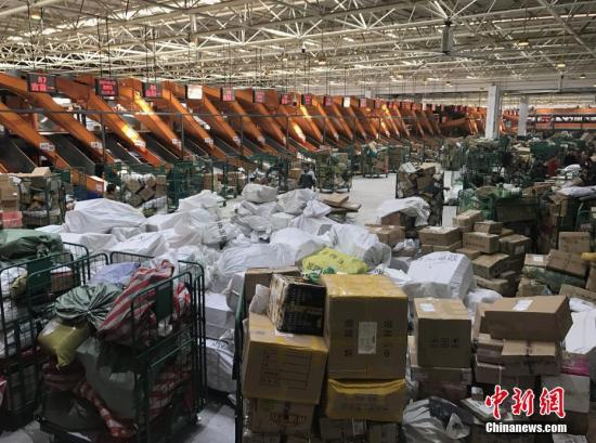 1月20日,，湖南長沙郵區(qū)中心局的工作人員正在處理堆積的快遞包裹。隨著中國春節(jié)的臨近,，為了避開實體店購物的擁擠和繁瑣,，越來越多的人選擇網(wǎng)絡(luò)購置年貨，快遞行業(yè)也隨之迎來“春運”高峰,。<a target='_blank' href='http://www.chinanews.com/'>中新社</a>記者 唐小晴 攝