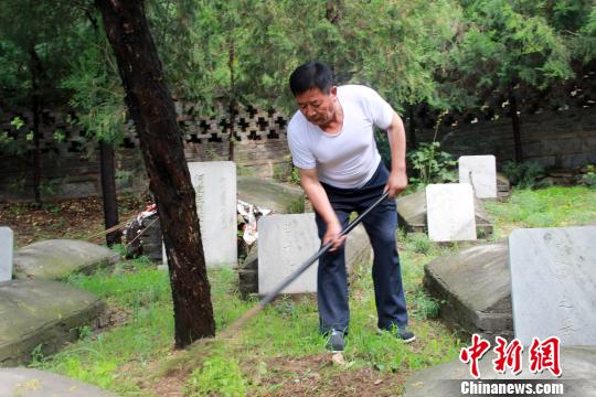 趙玉山在烈士墓園內(nèi)鋤草,。　于俊亮 攝