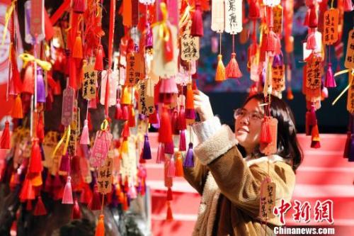 資料圖：民眾在上海大世界感受“海派年味”，游客在許愿樹(shù)下祈福新年,?！珡┛?攝
