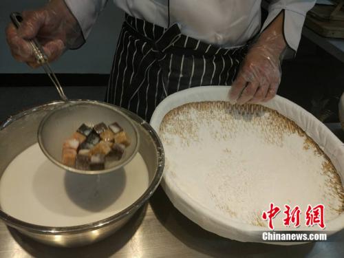 制作元宵時(shí),，首先要將餡料做好,，沾上水，再投進(jìn)盛滿糯米粉的笸籮內(nèi)搖,。<a target='_blank' href='http://www.chinanews.com/' >中新網(wǎng)</a> 李金磊 攝