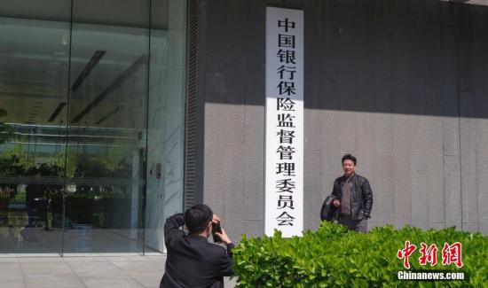 4月8日，中國銀行保險監(jiān)督管理委員會在北京正式掛牌,，民眾與新牌合影,。<a target='_blank' href='http://www.chinanews.com/'>中新社</a>記者 賈天勇 攝