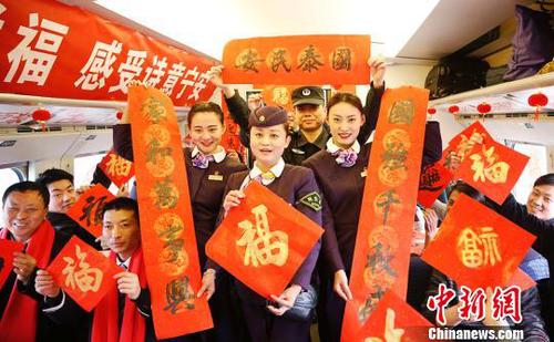 列車員和乘客一起展示春聯(lián)和福字,?！垕I子　攝