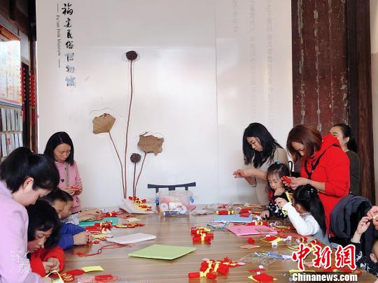 家長帶著小朋友參與趣味手工體驗活動,?！∪~秋云 攝