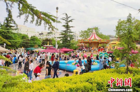 5月4日，金城公園游樂(lè)場(chǎng)內(nèi)家長(zhǎng)帶著孩子享受假期時(shí)光,?！「哒?攝