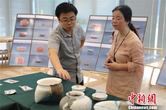圖為文物遺存進(jìn)行展示,?！」芤帏Q 攝