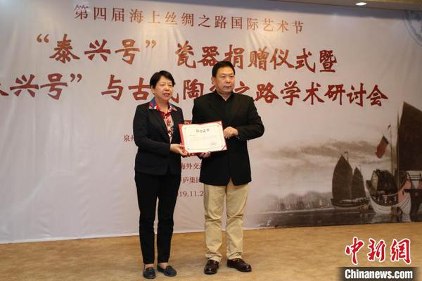 泉州市副市長周真平(左)為“泰興號(hào)”沉船瓷器捐贈(zèng)者鄭長來頒發(fā)收藏證書?！＄娦?攝