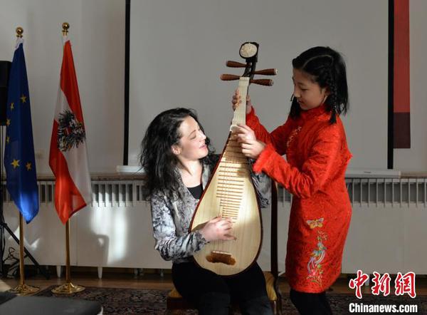 圖為中國文化小使者琵琶獨奏《彝族舞曲》,，霓娜體驗琵琶指法,。主辦方供圖