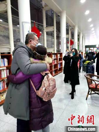 資料圖：圖為山東首批醫(yī)療隊深夜集結支援武漢,，醫(yī)護人員出發(fā)前和家屬擁抱告別?！∏窠?攝