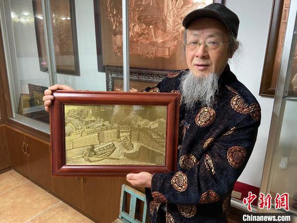 趙秀林舉著一幅蘊(yùn)含紹興風(fēng)光的銅雕作品,?！№?xiàng)菁 攝