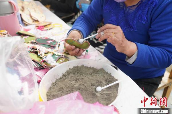 圖為工人在裝青繡防疫荷包里的中草藥?！∥乃碱?攝