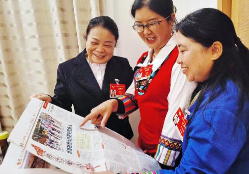 住滇全國政協(xié)委員黃麗云,、丁秀花、資艷萍（從左至右）閱讀人民政協(xié)報(bào),，就更好的培養(yǎng)孩子們成為新時(shí)代接班人等教育問題各抒己見,。 特邀委員記者 茸芭莘那 攝